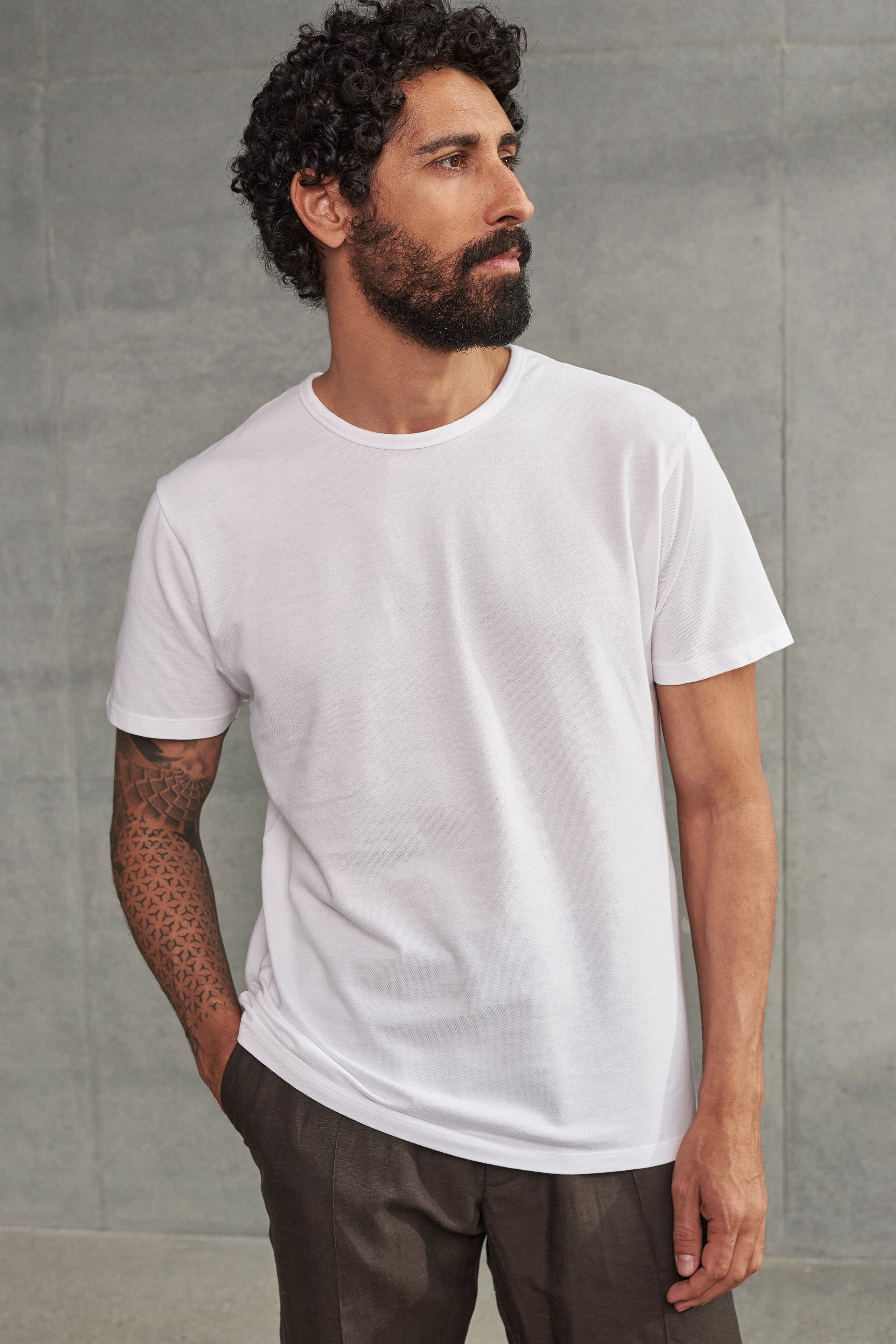 A person wearing a white crew neck t-shirt.